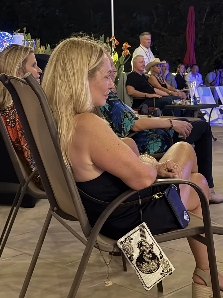 Guests listening at an outdoor music gathering