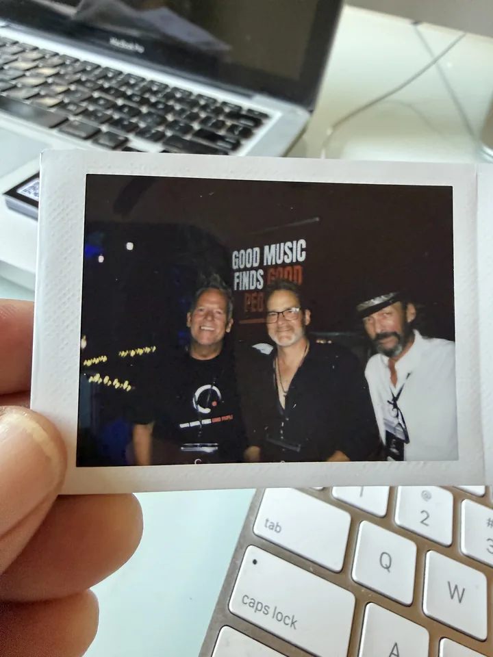 Printed photo of AMPD team members beside a laptop