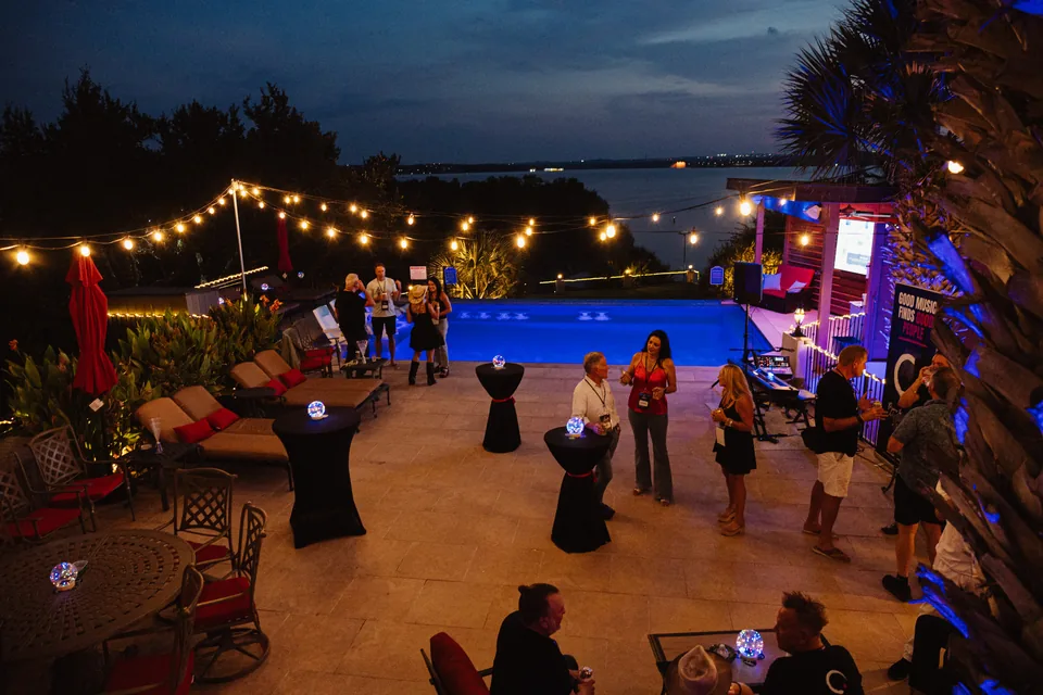 Outdoor AMPD launch venue beneath string lights at dusk