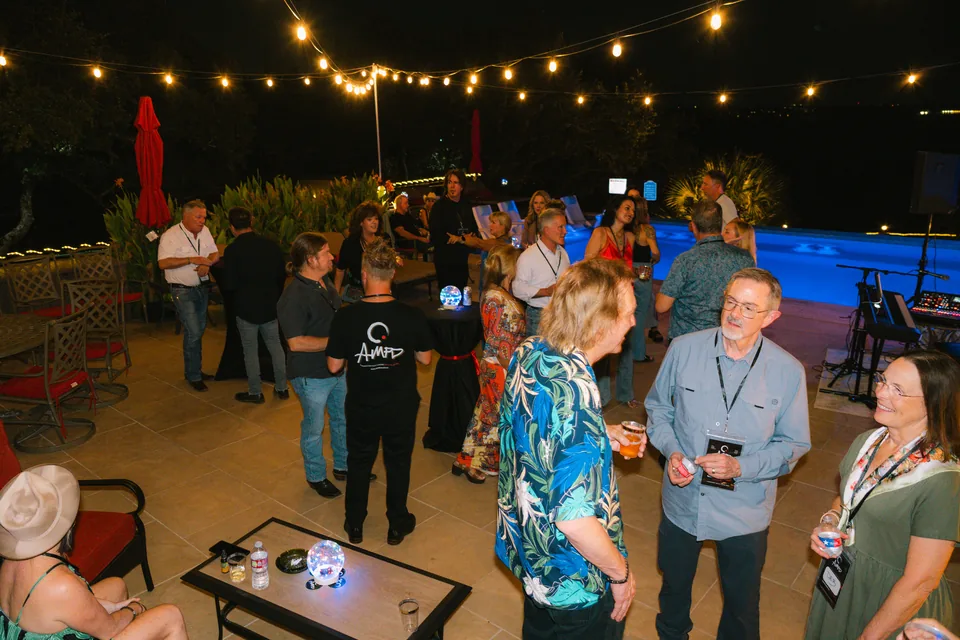 Guests gathering beneath string lights at the AMPD launch