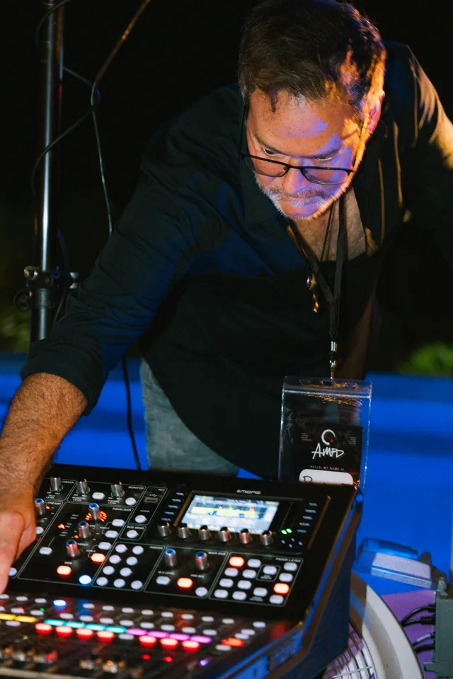 Sound operator adjusting the mixing console